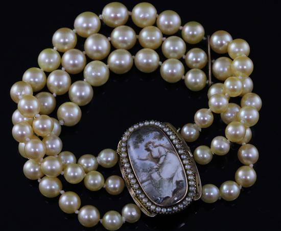 A triple strand cultured bracelet, now with a Regency gold mounted oval panel mourning clasp,